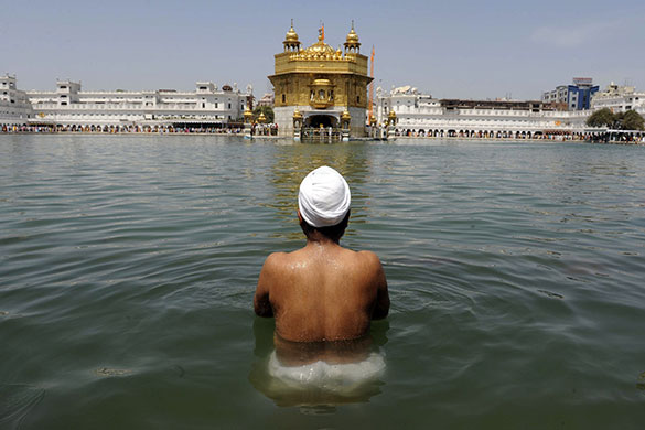 Sikh festival: A Sikh devotee takes a dip in the Holy Sarovar 