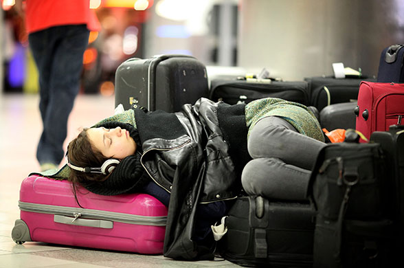 Iceland volcano: A girl sleeps in the departure lounge at Gatwick airport