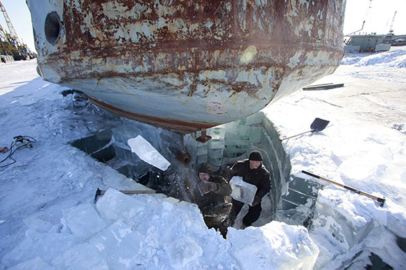 24 hours: Khatanga, Russia: Workers remove ice blocks from under a ship 