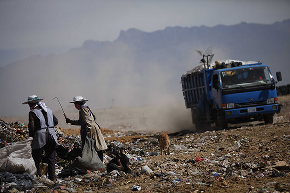 24 hours: Cochabamba, Bolivia: Women retrieve items from the Kara Kara rubbish dump