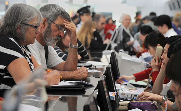 Travel chaos: Passengers speak with Cathay Pacific employees at Hong Kong's airport