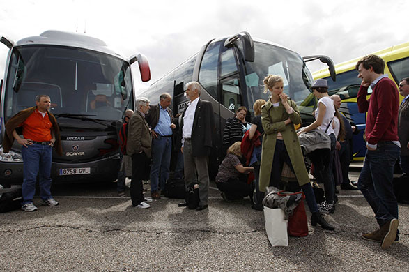 Travel chaos: Lufthansa passengers wait in front of a bus bound  for Munich