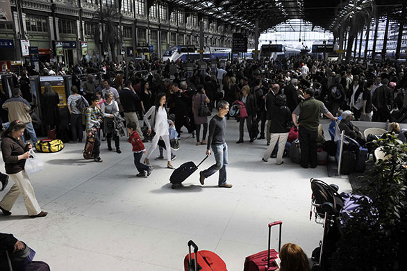 Travel chaos: Travellers wait at the Gare de Lyon railway station in Paris