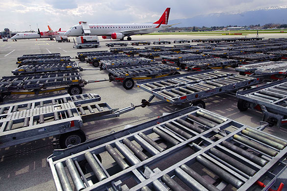 Travel chaos: Cargo trolleys parked on the tarmac at Cointrin Geneva's Airport