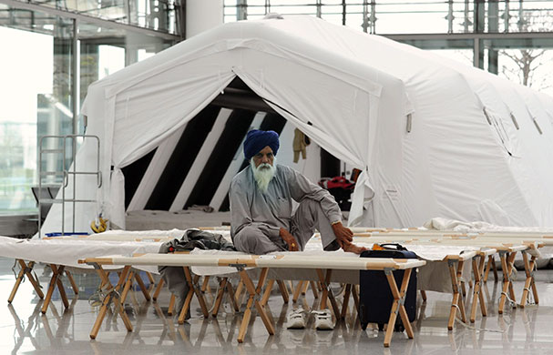 Travel chaos: An Indian traveller waits in emergency accommodation