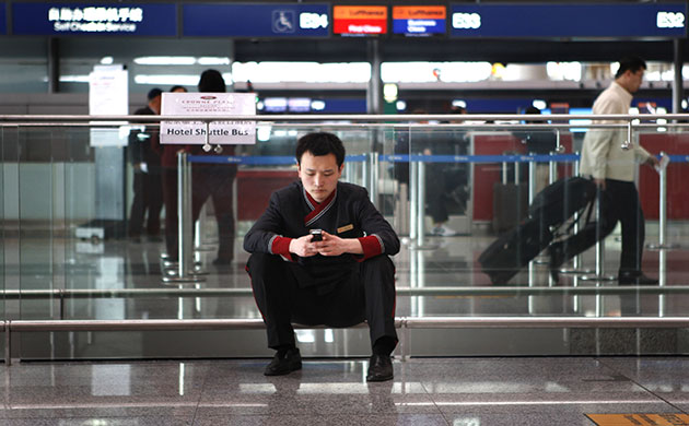 volcano travel chaos: A hotel shuttle bus assistant  at Beijing's international airport
