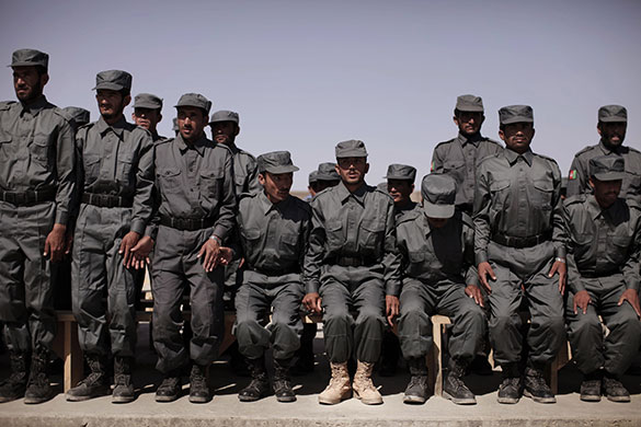 24 hours in pictures: Afghanistan: Police rise for the national anthem