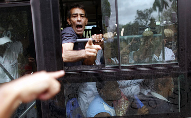 24 hours in pictures: Havana, Cuba: A man shouts from the inside of a bus