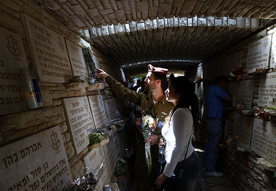 24 hours in pictures: Jerusalem: An Israeli soldier lays flowers on a wall