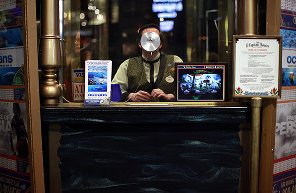 24 hours: Los Angeles, USA: A man sits in a box office at the El Capitan Theatre 