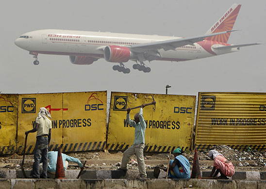 24 hours: New Delhi, India: Indian migrant labourers work at a construction project