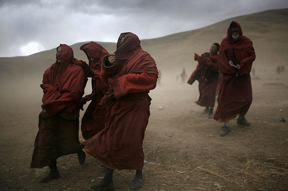 China earthquake: Tibetan monks walk amid sandstorms