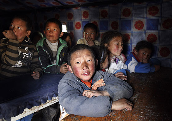 China earthquake: Tibetan children sit inside their temporary makeshift school