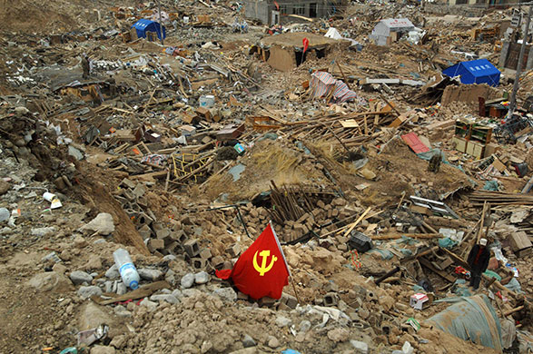 China earthquake: A Communist party flag lies amidst the rubble of buildings in Jiegu
