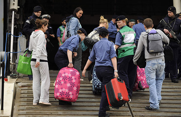 Stranded passengers: Royal Navy sailors help passengers stranded by flight cancellations