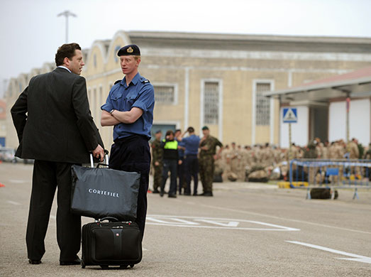 Stranded passengers: A British civilian talks to a British soldier before boarding HMS Albion