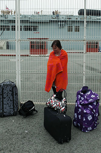 Stranded passengers: A British passenger who did not manage to board on HMS Albion, waits