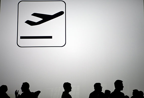 24 hours in pictures: Beijing, China: Air passengers wait to get on a bus to a hotel