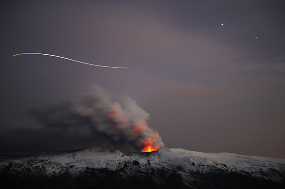 24 hours in pictures: A plane flies over the top of an erupting volcano near Eyjafjallajokull