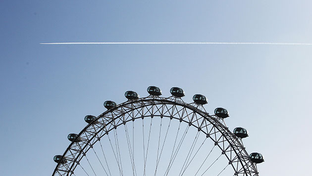 Airspace reopens: A plane flies over the London Eye after the UK's skies reopened
