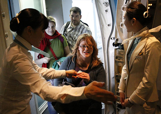 Airspace reopens: Korean Air flight attendants guide passengers to their seats
