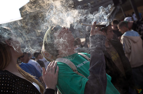 24 hours in pictures: Denver, US: A man smokes a joint at a pro-marijuana 