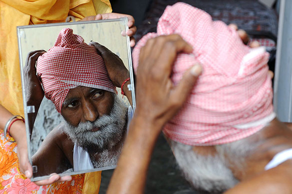 24 hours in pictures: Mahal village, India: Balbir Singh wraps his turban at his residence