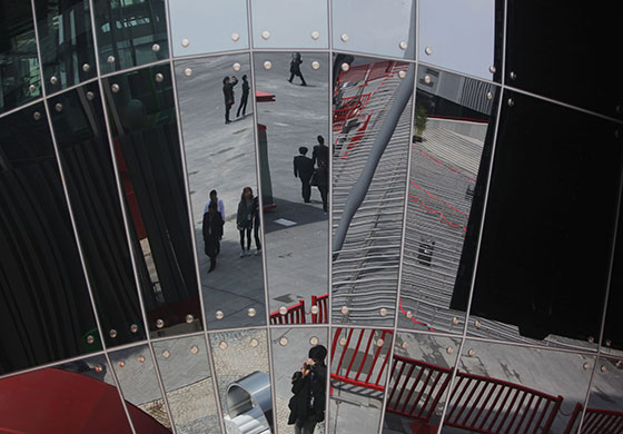 Shanghai Expo: Passersby are reflected in the Macau Pavilion at Shanghai 2010 World Expo