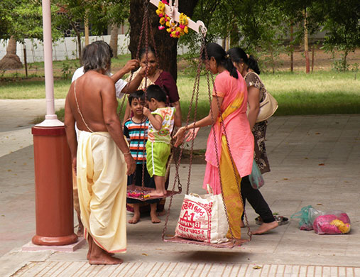 In Pictures: scale: small child being weighed against a bag of sugar