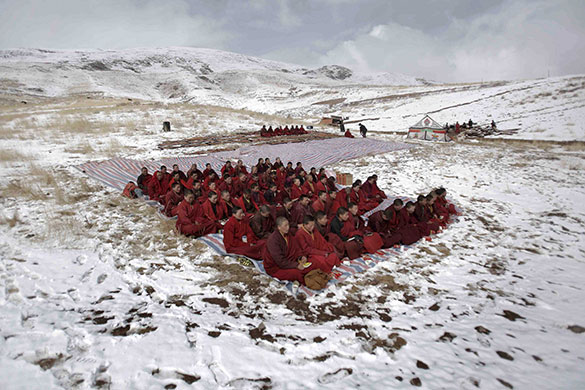 24 hours in pictures: Jiegu, China: Tibetan monks attend a mass prayer for earthquake victims 