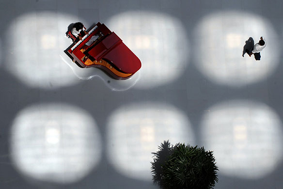 24 hours in pictures: Mumbai, India: A pianist plays in the lobby of The Oberoi hotel