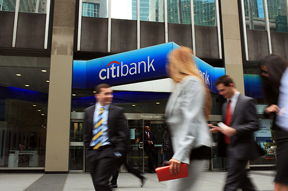 Week in Business: People walk by a Citibank office in midtown Manhattan