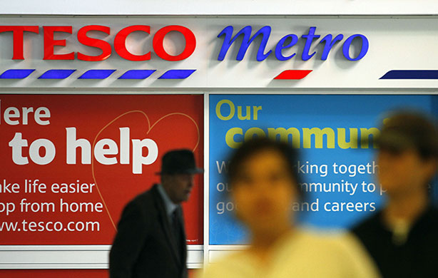 Week in Business: People walk past a Tesco supermarket in London