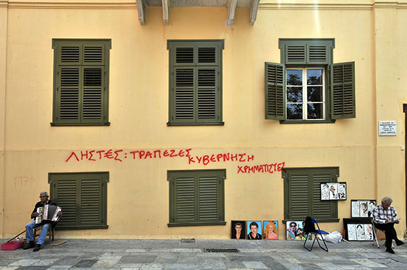 Week in Business: Graffiti on a house in Athens about the economic situation