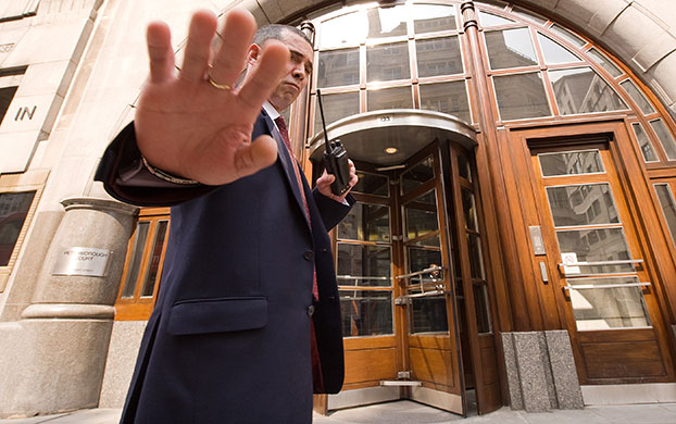Week in Business: A security guard tries to stop a photographer outside Goldman Sachs London