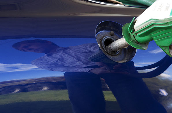 Week in Business: A motorist uses a petrol pump on a Gulf petrol station forecourt