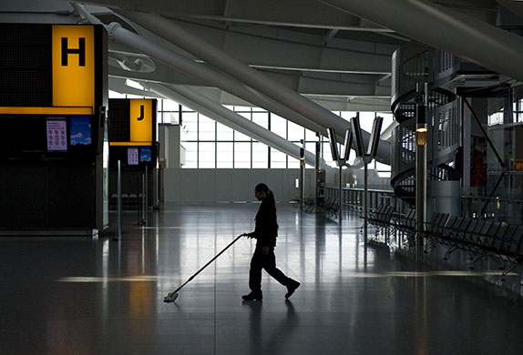 Week in Business: A cleaner works at a quiet Heathrow Terminal 5 after flights were cancelled