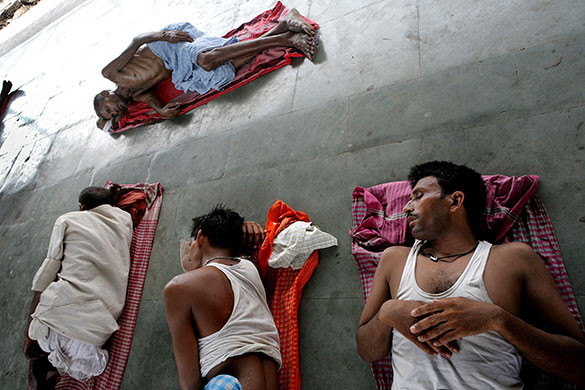24 hours in pictures: Kolkata, India: Labourers take a nap at Sealdha rail station