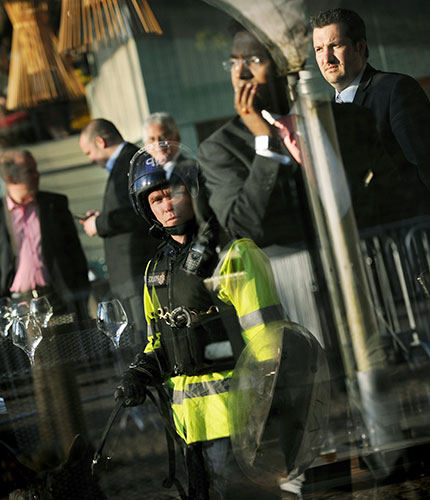 24 hours in pictures: Bristol, UK: A police dog handler is reflected in a window