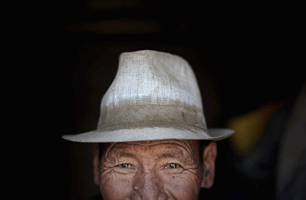 24 hours in pictures: Naidong County, China: Tibetan farmer Baima Jiumei