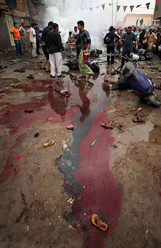 Baghdad bombings: Shoes are strewn amid pools of blood on a street