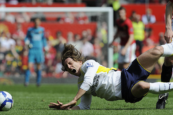 United v Spurs: Luka Modric feels the force of a tackle