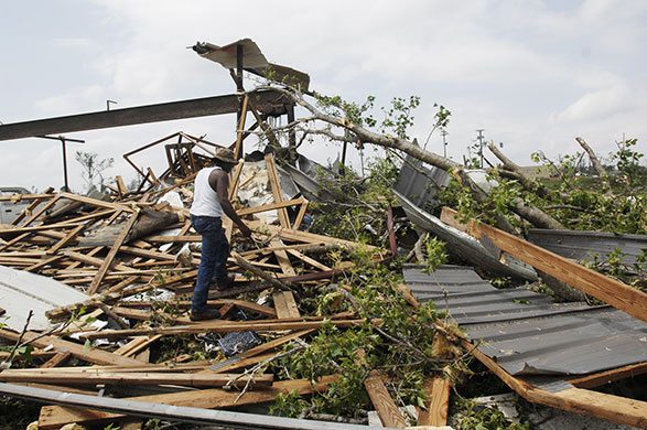 mississippi tornado: A man searches a damaged home for survivors
