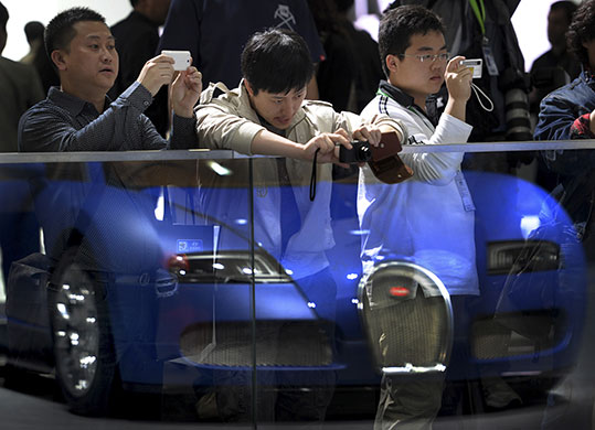 Beijing car show: Visitors takes souvenir photos of the Bugatti Veyron 16.4 Grand Sport