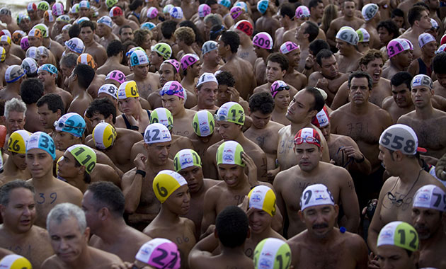 24 hours in pictures: San Felix, Venezuela: Swimmers are driven on a boat