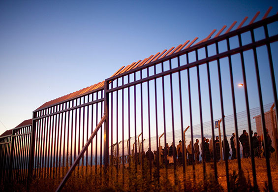 24 hours in pictures: palestinian workers queue before dawn to cross into israel