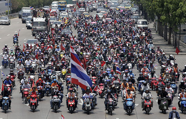 Thailand protests: Anti-government red-shirt protesters carry Thai national flags