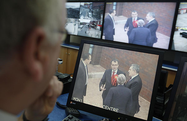 Election week 4: Police officers monitor the prime minister Gordon Brown on CCTV