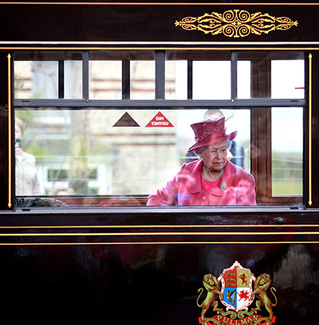 24 hours in pictures: Caernarfon, UK: Queen Elizabeth II sits in the carriage of a steam train
