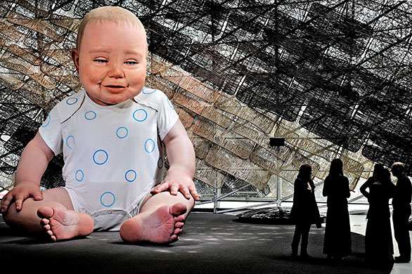 24 hours in pictures: Shanghai, China: People are dwarfed by a huge animated baby mannequin